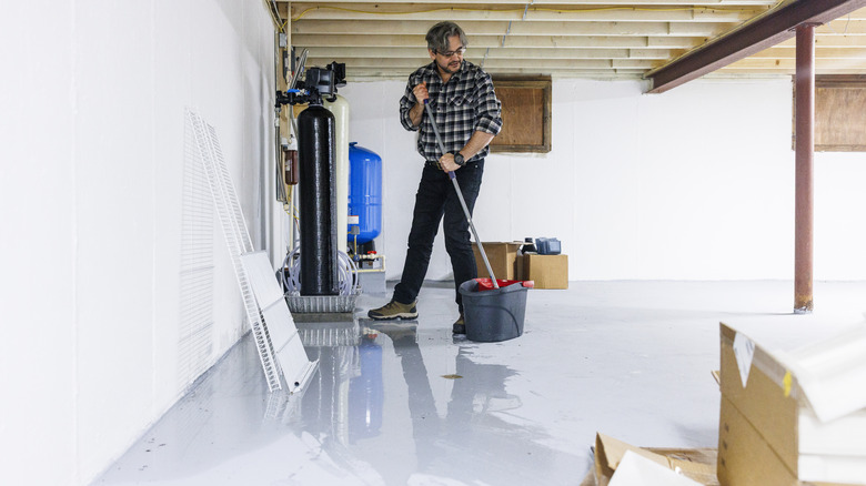 Homeowner dealing with basement waterproofing and water damage